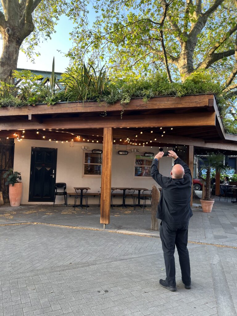 Man taking picture of the Casual Green Roof in London