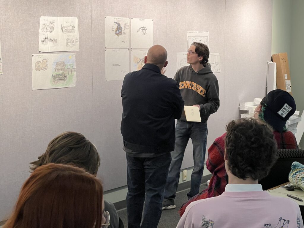 Dr. Ross critiquing student's drawings